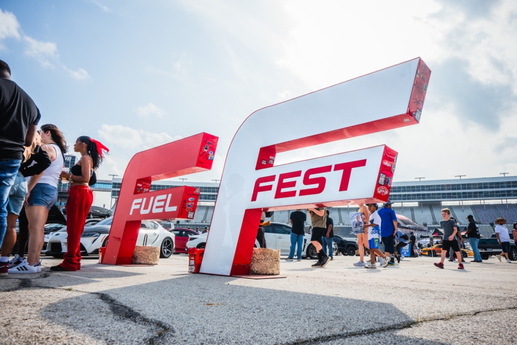 FuelFest signage and attendees gathered inside Texas Motor Speedway during the FuelFest Dallas-Fort Worth automotive festival.